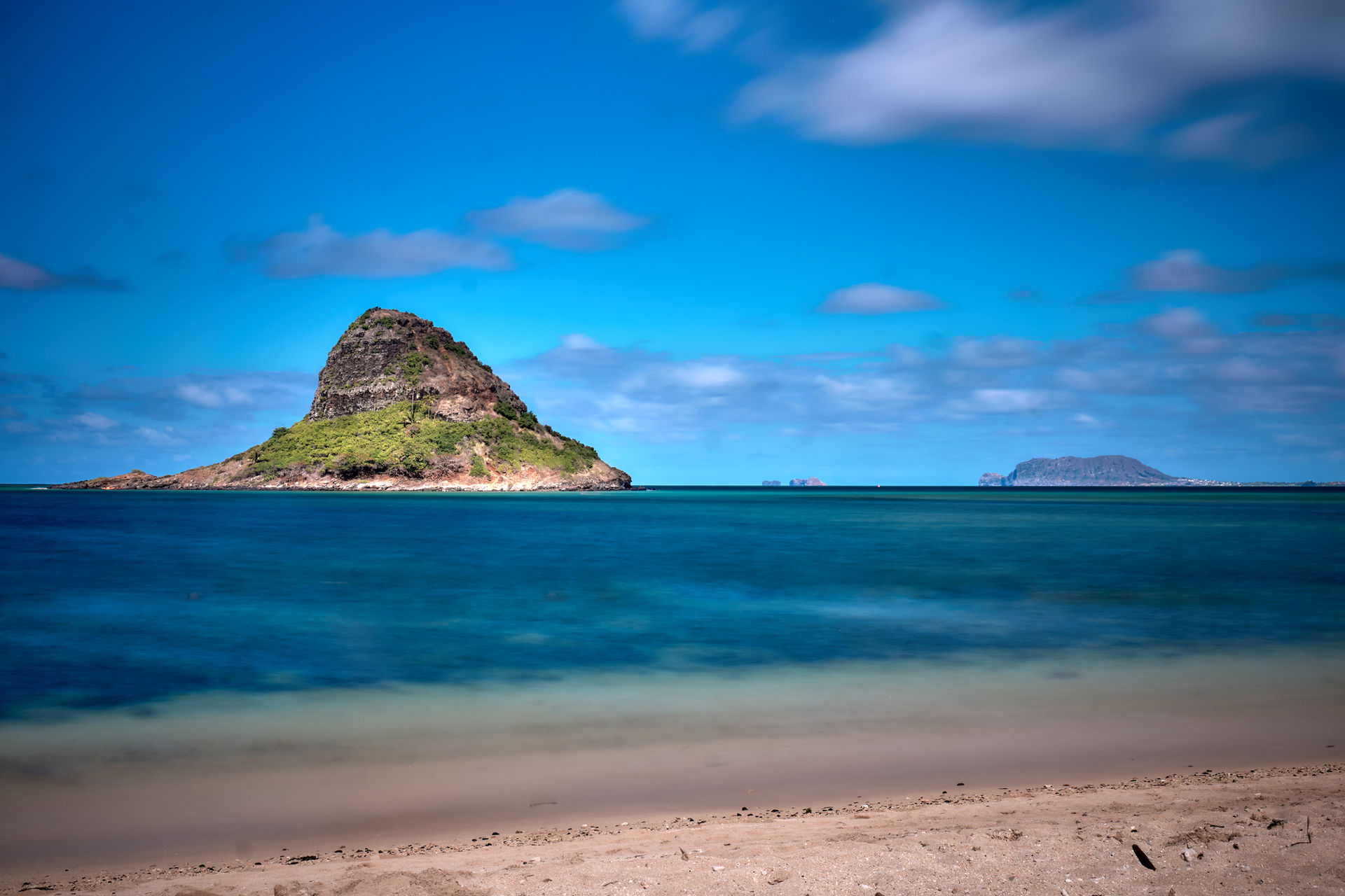 The view to Mokoli'i Island (Chinaman's Hat) from the beach at Kualoa Point. Mokapu and Pukaulua Points are in the distance