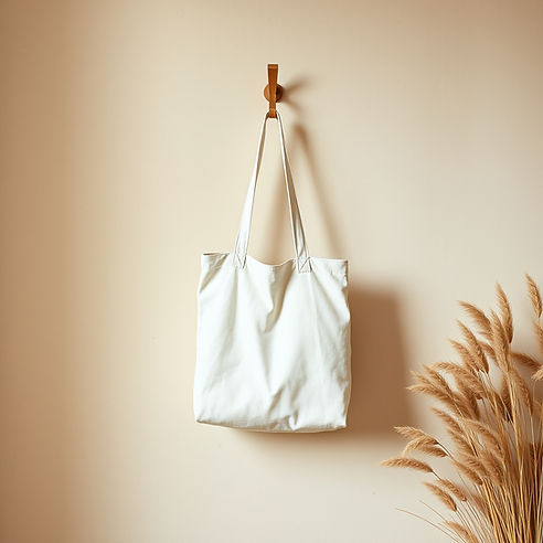 A cozy, lifestyle-focused aesthetic shot. An organic, unbleached cream-colored grocery tot