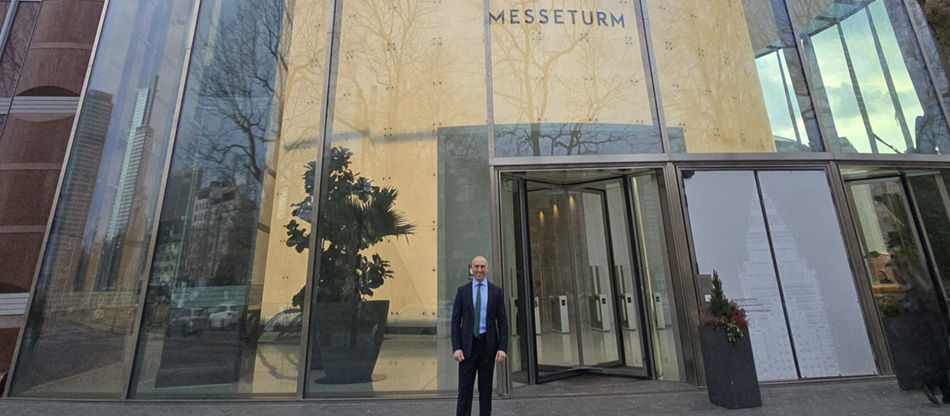 Man standing at the entrance of an office Building