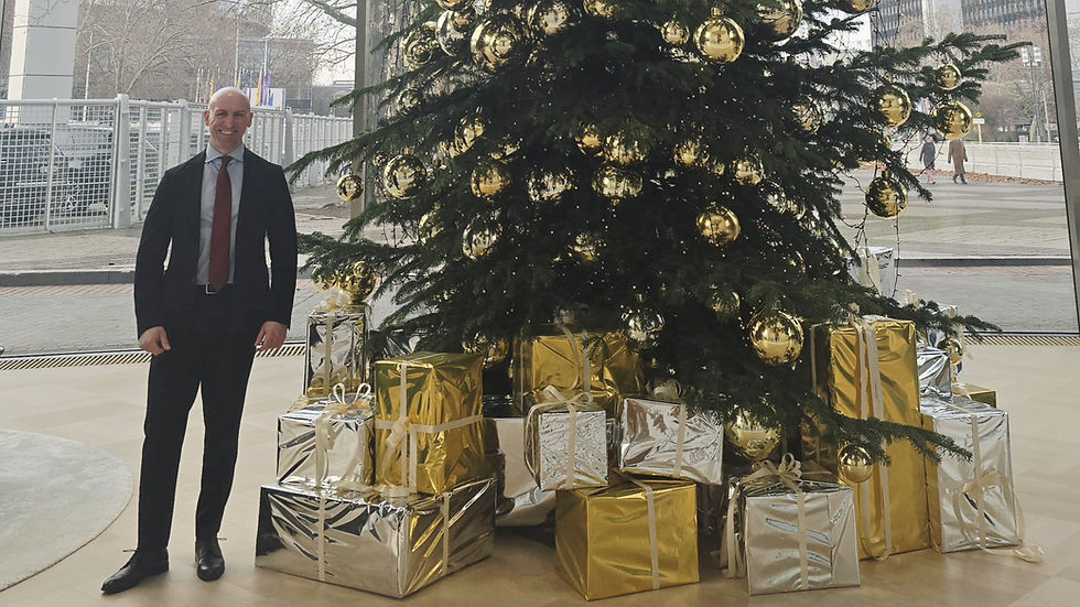 Man standing at a christmas tree