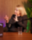 Woman speaking into a microphone during a podcast recording