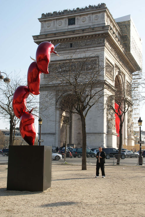 Patrick Laroche exhibition of his contemporary Vegetables sculpture: giant colorful red chili pepper at the Arc de Triomphe, Paris France.