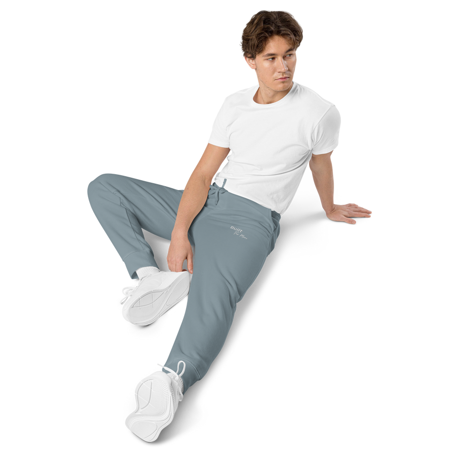Man sitting in Built for More Premium Cotton Sweatpants.