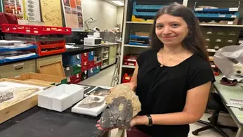 Dr. Melina Jobbins poses with a fossil fish