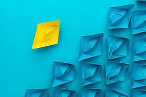 yellow-paper-ship-out-of-the-crowd-conce