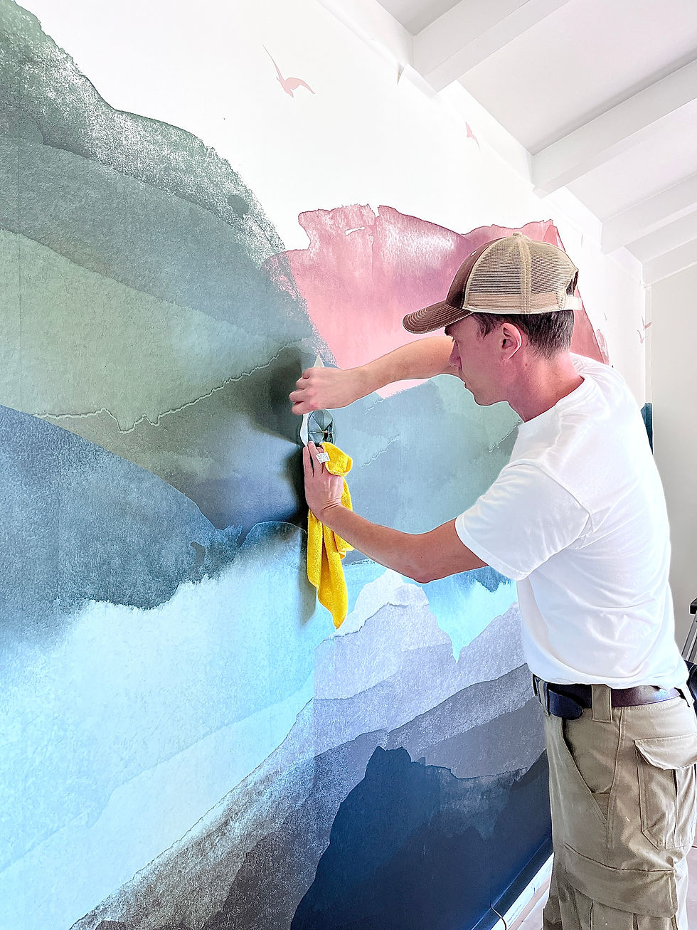 Close-up view of wallpaper pattern being aligned on a wall