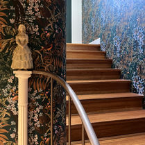 Hallway with rounded corners and dark wallpaper