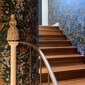 Hallway with rounded corners and dark wallpaper