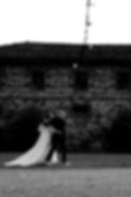 Bride and groom walking arm in arm outside an elegant wedding venue in Italy during their destination wedding, enjoying a romantic moment together.
