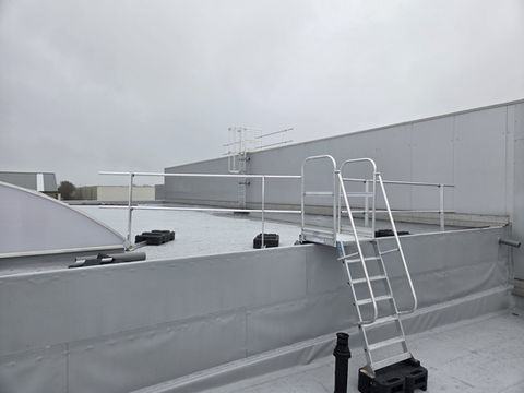 Kooiladder met leuningwerken en een overstapbordes