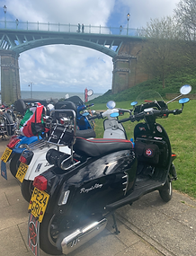 Scooters parked by the bridge at the Scarborough Spa display for the National Scooter Rally.