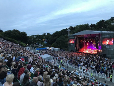 Big crowd at Scarborough Open Air Theatre enjoying a live concert on a summers evening
