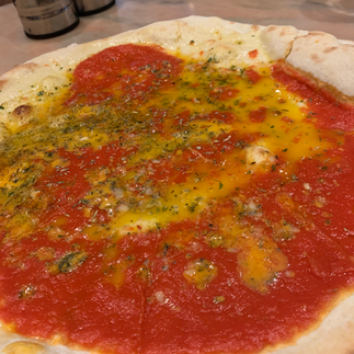 Thin garlic bread topped with tomato, garlic butter, chilli, and melted Stilton cheese