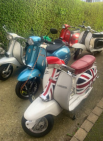 Scooters parked off‑road beside The Headlands Hotel for the National Scooter Rally.