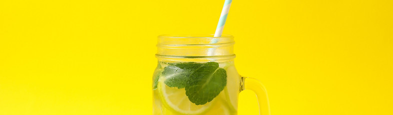 glass-jar-with-lemonade-yellow-surface-fresh-drink.jpg