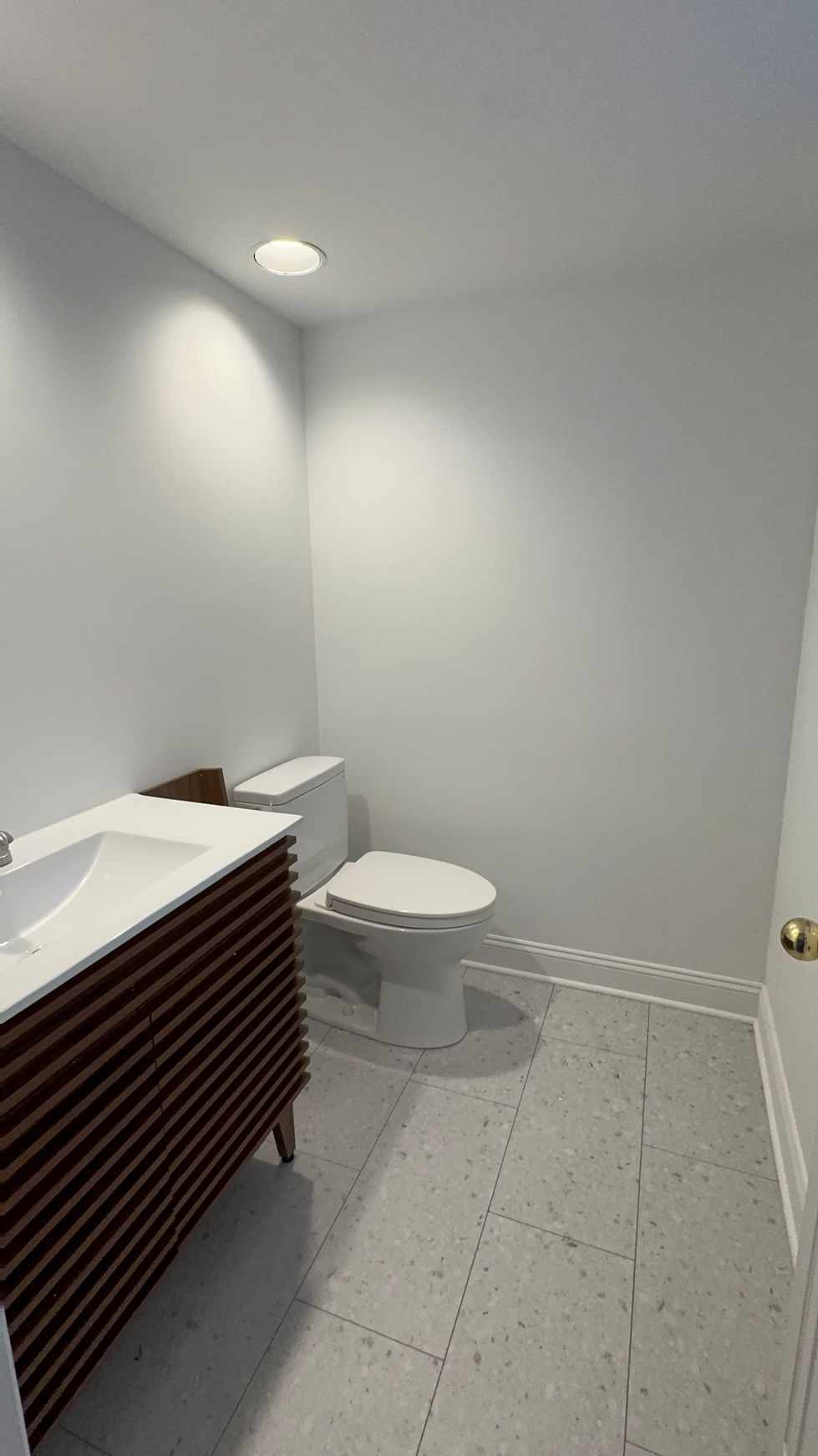 Updated half bathroom featuring modern vanity sink and clean minimalist design.