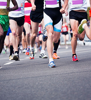 People running in a marathon on an asphalt surface