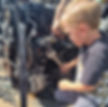 boy using a spanner to take apart engine