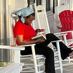 Picture of Korey reading outside 