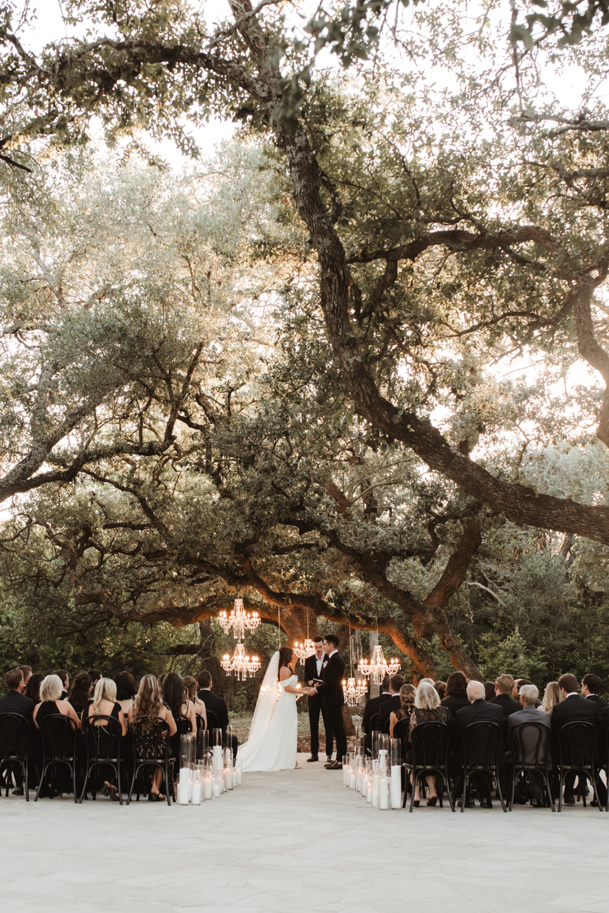 Romantic ceremony design featuring chandeliers and gold accents at The Addison Grove wedding venue