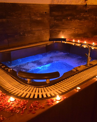 Jacuzzi tub with lights and flower decorations