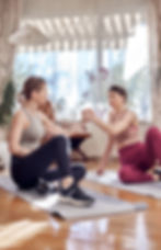 2 women giving each other a high five after a work out