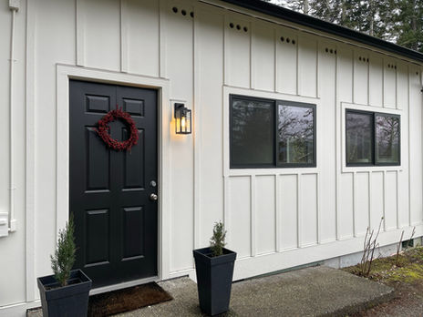 Milgard Trinsic V400 black vinyl half vent windows installed in a charming waterfront home on Fox Island, WA.