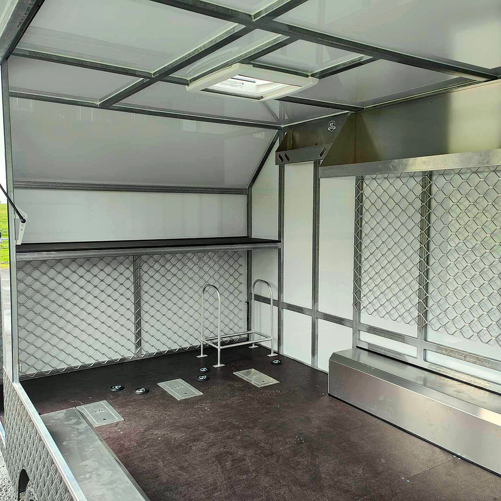 inside of enclosed dirt bike trailer with security mesh and alloy gear racks