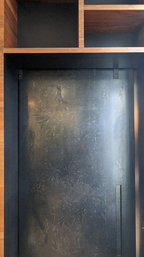 blackened steel door detail with French walnut shelving
by Aethos Atelier
