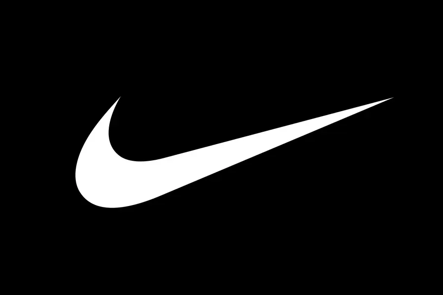 White Nike swoosh logo on a black background representing branding consistency, used in our Los Angeles real estate marketing article.