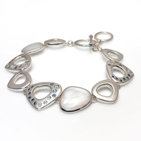 Chunky flat link silver bracelet set with a scattering of tourmalines, sapphires and aquamarines, and mother of pearl sections, by Heather O'Connor