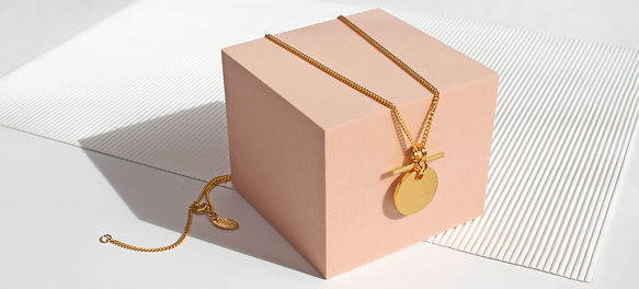 a gold vermeil shimmer textured disk and tbar pendant with curb chain