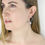 Thumbnail: Silver pillow circle drop earrings being worn