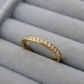 Gold eternity band ring with multiple small diamonds in grey velvet ring tray, bespoke jewellery, heather O'Connor.