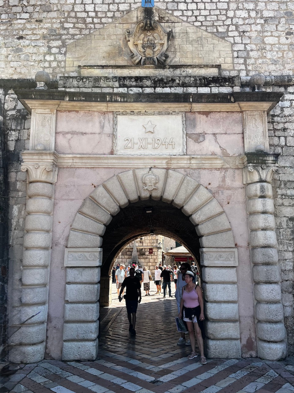This pinkish gate is the Main Gate or Sea Gate that leads directly inside the Old Town at the Square of Arms; 1 Day in the Walled City of Kotor, Montenegro: the Top 10 Things to Focus on