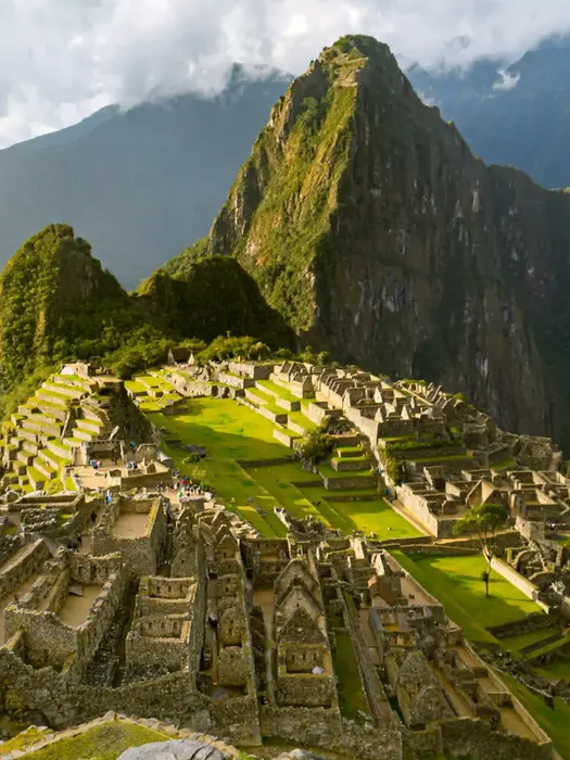Aerial view of Machu Picchu ruins amid misty mountains