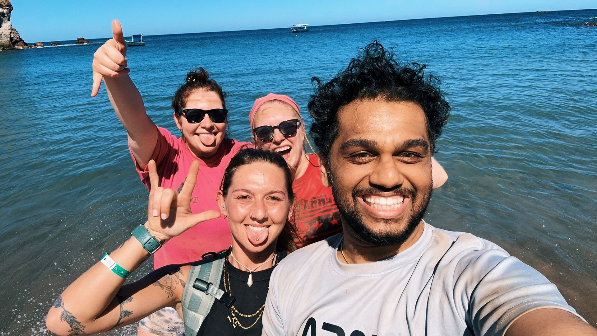 FTLO group trip travelers taking a beach selfie during a group travel adventure for solo travelers in their 30s.