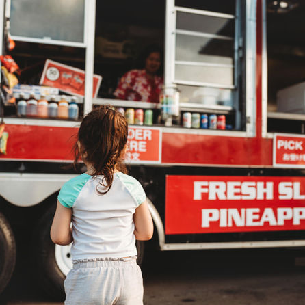 girl standing in front of food truck