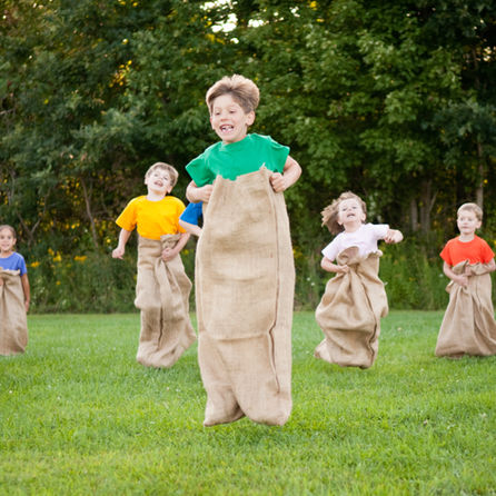 Children in a potato sack race at Kids Day America event.