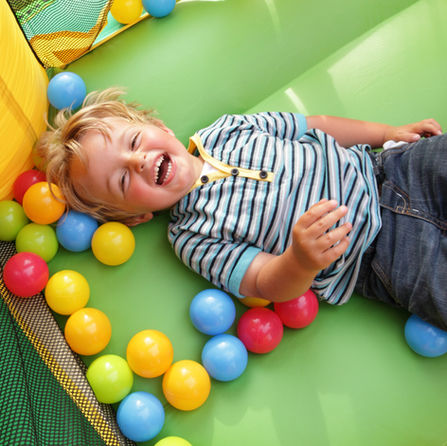 Young boy in bounce house laughing at Kids Day America event in west Cobb.