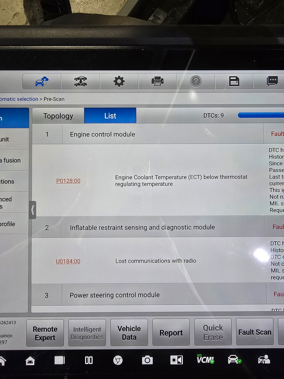 Vehicle diagnostic scan screen listing fault codes, including P0128 coolant temperature and U0184 lost radio communication.