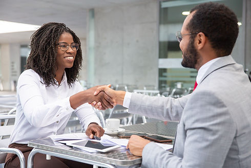 smiling-businesswoman-shaking-hands-with-partner.jpg