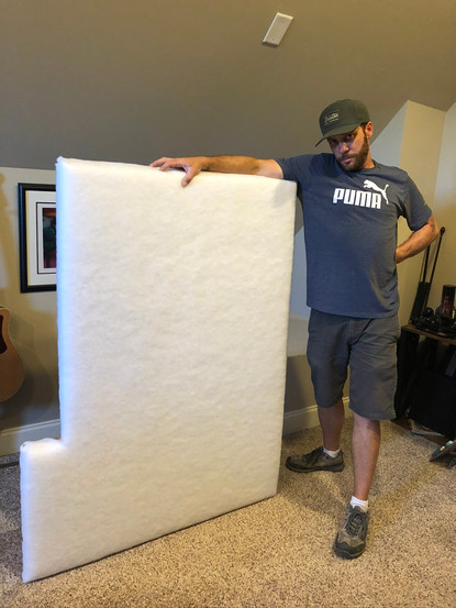 Carpetner after adding cushioning to a uniquely shaped corner cushion.