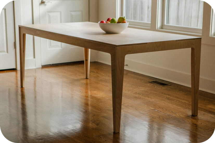 A modern table built by Paper and Pipes. It looks like it's built from white oak plywood.