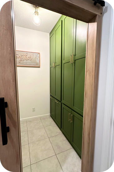 Bright green built-in cabinets that range from the floor to the ceiling in size.