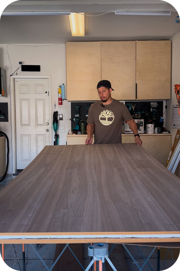 Christopher Ducan of Duncwoods inspecting a piece of walnut plywood prior to a project. 