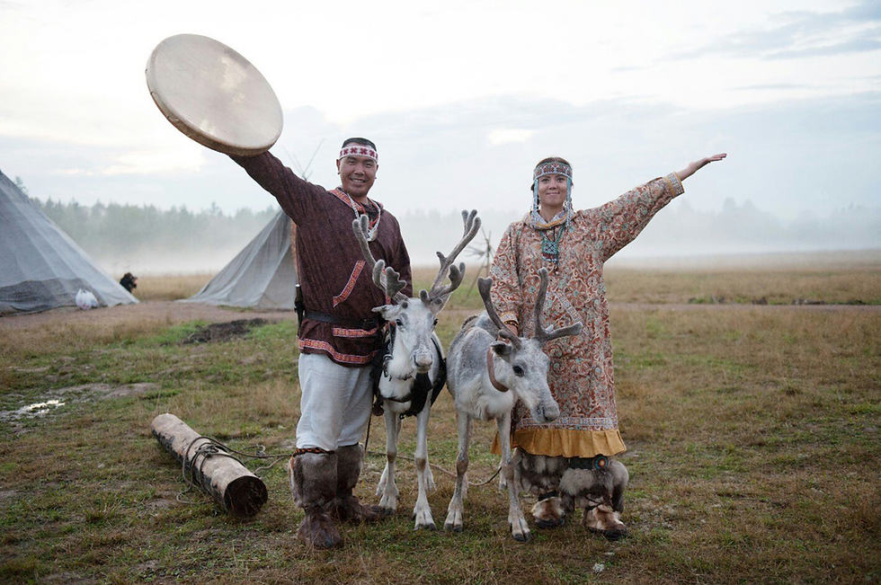 A chukchi man and woman pose with reindeer in Chukotka. Russia Beyond