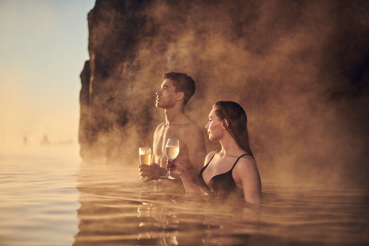 A couple enjoying geo-thermal bathing. Photo credit: Sky Lagoon near Reykjavík, Iceland