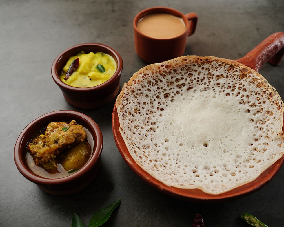 Appam with Potatoes and a stew preparation. Versions with vegetable (instead of meat) are often available. This is a breakfast dish from Kerela, India