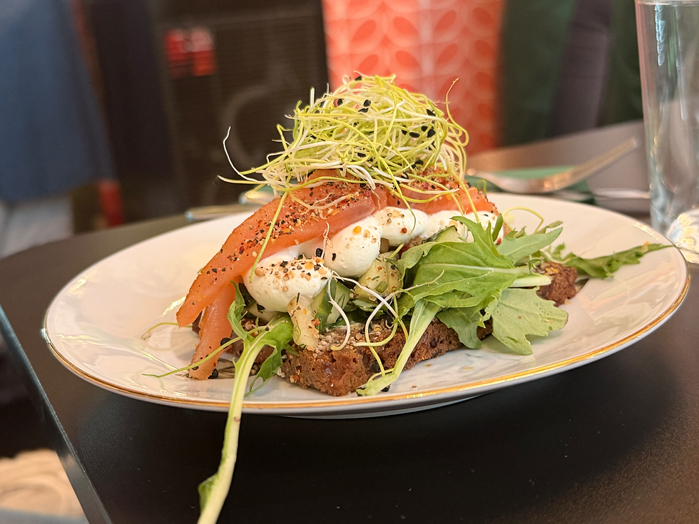 Smoked Danish salmon with apple, cucumber-red onion salad and smoked cheese cream served on traditional rugbrød at Iben’s Smørrebrød in Copenhagen.